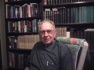 Charles Devon in front of his library